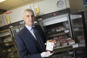 Dr. Dean Fergusson holding a unit of blood