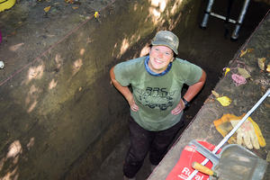 Researcher in a trench.