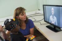 Professor Clare Elwell with An African Baby Wearing the near Infra-Red Spectroscopy Monitor