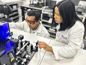 Researchers with a demonstration of their experimental set up for their new neuromorphic vision device