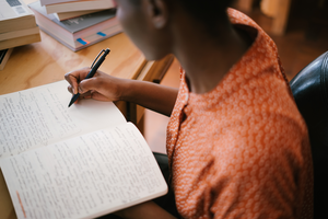 A woman writing in a notebook.