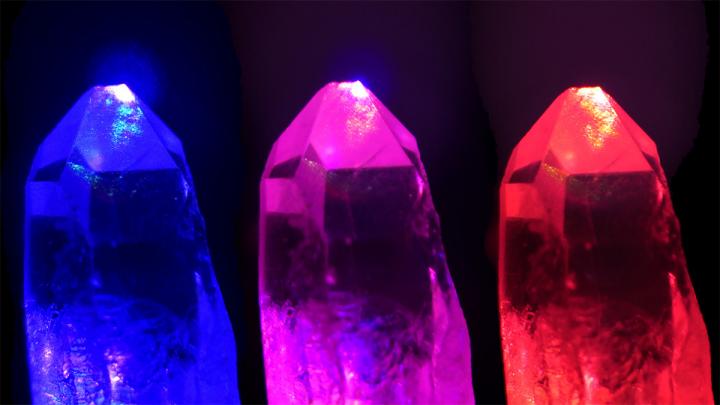 Three crystals - blue, pink, red - on black background