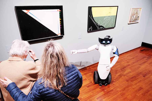 R1 humanoid robot explaining Lucini's work