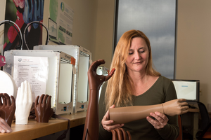 Jade Myers Holding Prosthetic Limb