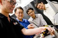 NTU team of scientists discussing the experimental results from the topological laser prototype