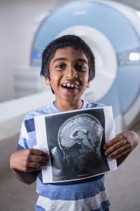 Dhild with Autism Holding Brain Scan