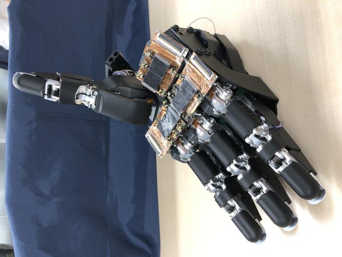 Honda robot hand with the soft skin sensors added to the palm