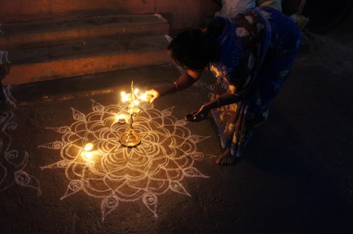 A Woman Lights An Oil Lamp to Celebrate the Hindu Festival of Lights