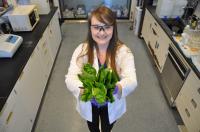 Nichola M. Kinsinger Holding Spinach in Lab
