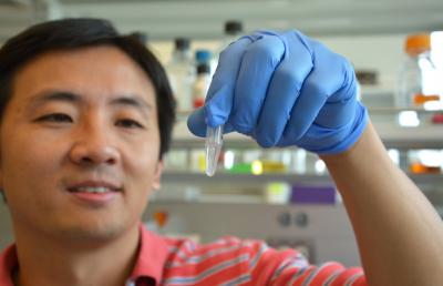 Peng Mao Holding a Vial of DNA