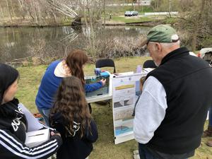 Rachel King, from UMass Amherst, demonstrating how saltwater intrusion works to members of the public in Plymouth, MA, during the 2023 Herring Run Celebration.