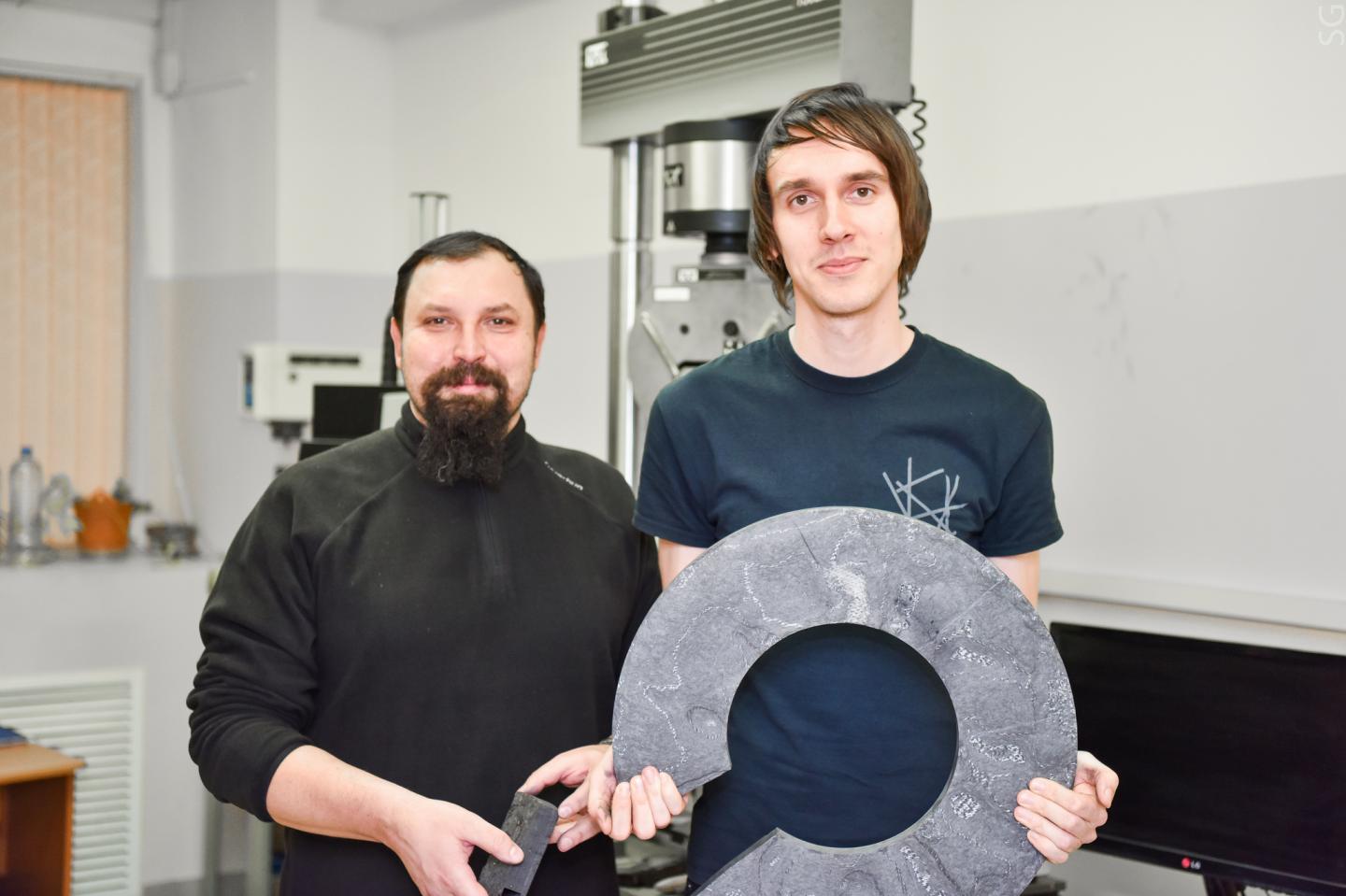 Research Team with Fragments of Carbon-Carbon Materials