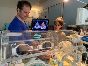 Pediatric cardiologist Dr. Holger Michel during a cardiac ultrasound examination of 7-​week-old Jarmo in the presence of his mother.