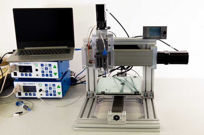 A 4D printer for smart materials with magneto-and electro-mechanical properties
