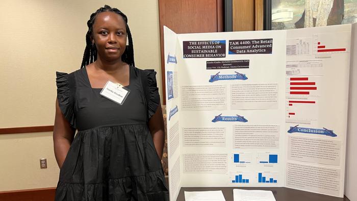 Atosha Jisabo, a textiles and apparel management (TAM) student, presents a data analytics project at TAM’s open house event.