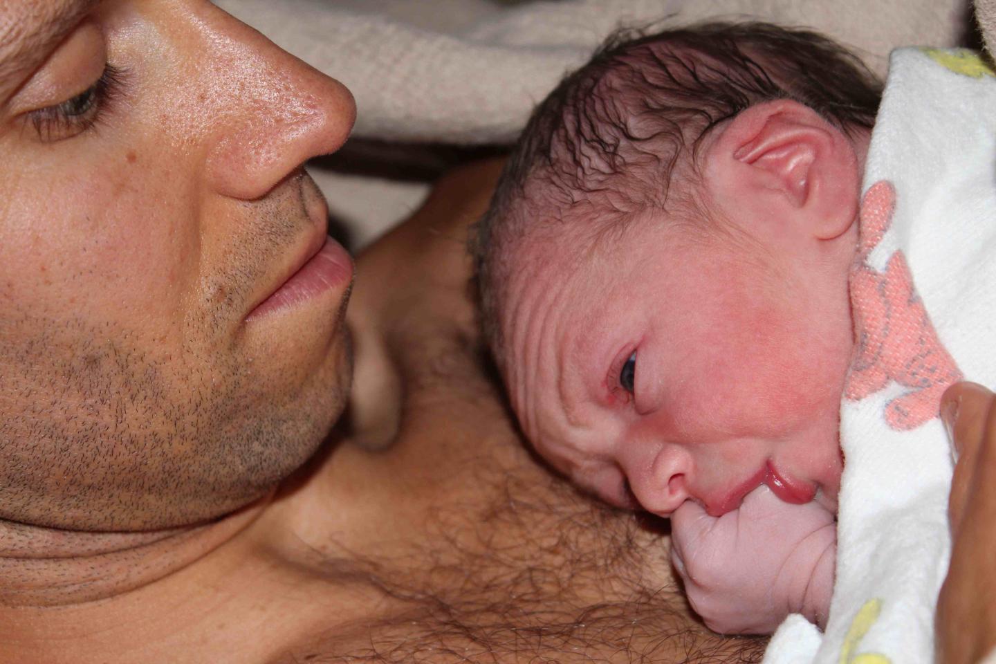Professor Lee Gettler Holds His Newborn Son