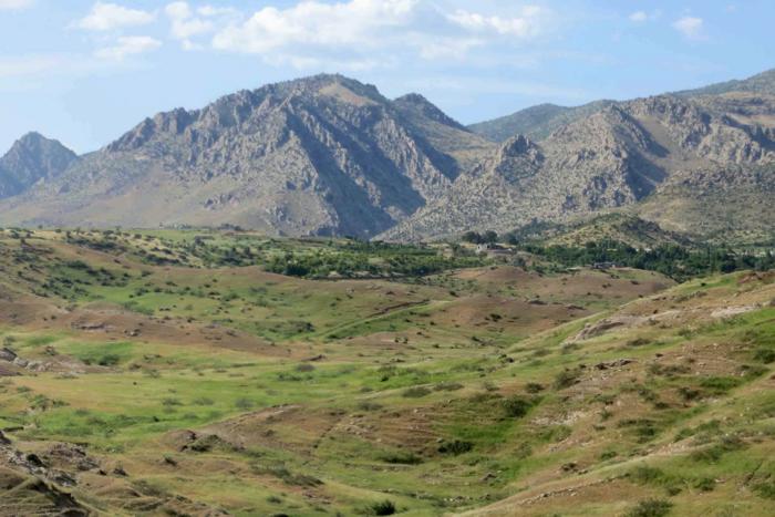 The Zagros Mountains and sediments that have accumulated over millions of years along the depression at the base of the mountains.