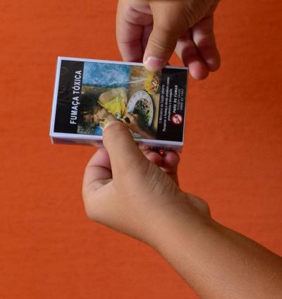 Brazilian Child Looks at Cigarette Health Warning Label