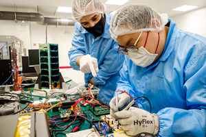 NTU undergraduate student Mr Tamas Szecsenyi (left) with his fellow researcher Mr Isaac Wong (right) working on the SCOOB-I at the NTU Satellite Research Centre