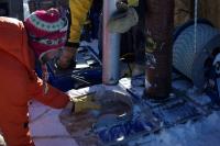 Drill Dripping Water from Greenland Ice Sheet