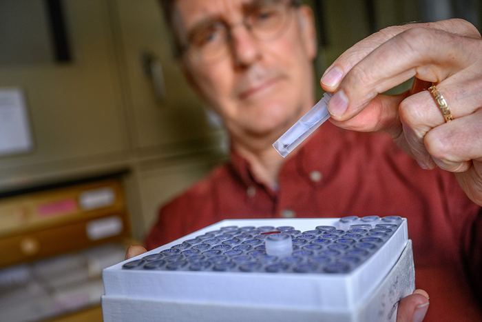 Christopher Dietrich with vials containing insect specimens