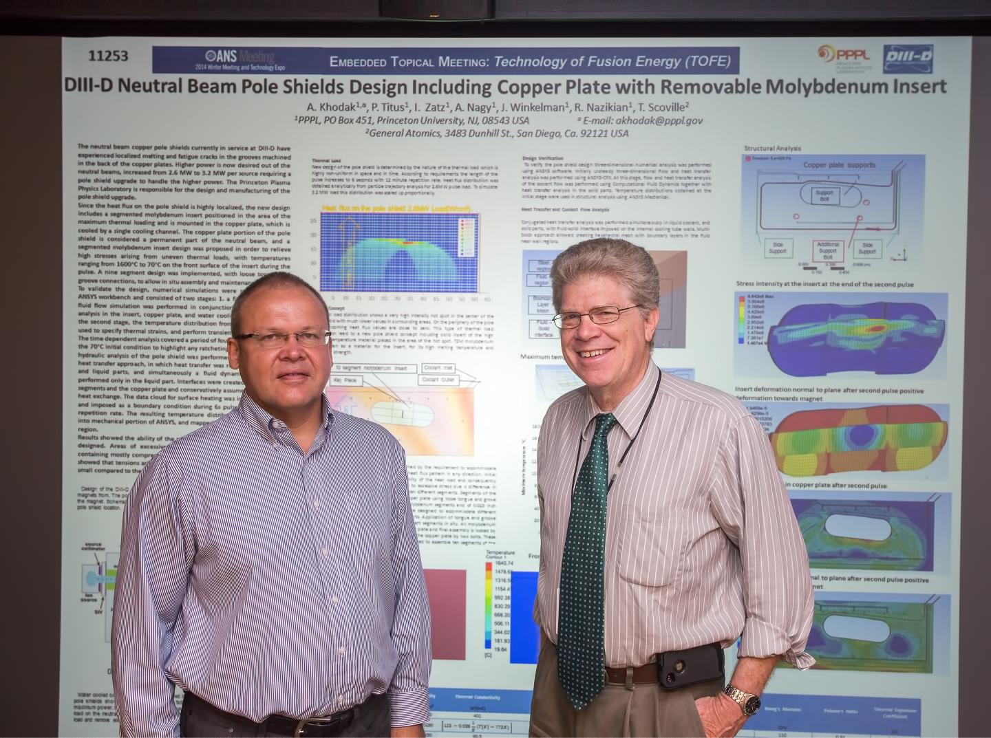 Engineers Andrei Khodak and Irving Zatz with Poster for Pole Shields