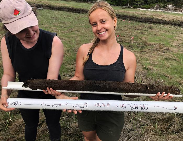 Co-author Bonnie Turek (center) holding a sediment core retrieved from a salt marh in Phippsburg, Maine.