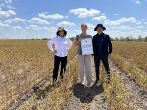 USDA Program Officer Loren Muldowney, participating farmer Courtney Moore, and principal investigator Woo-Suk Chang