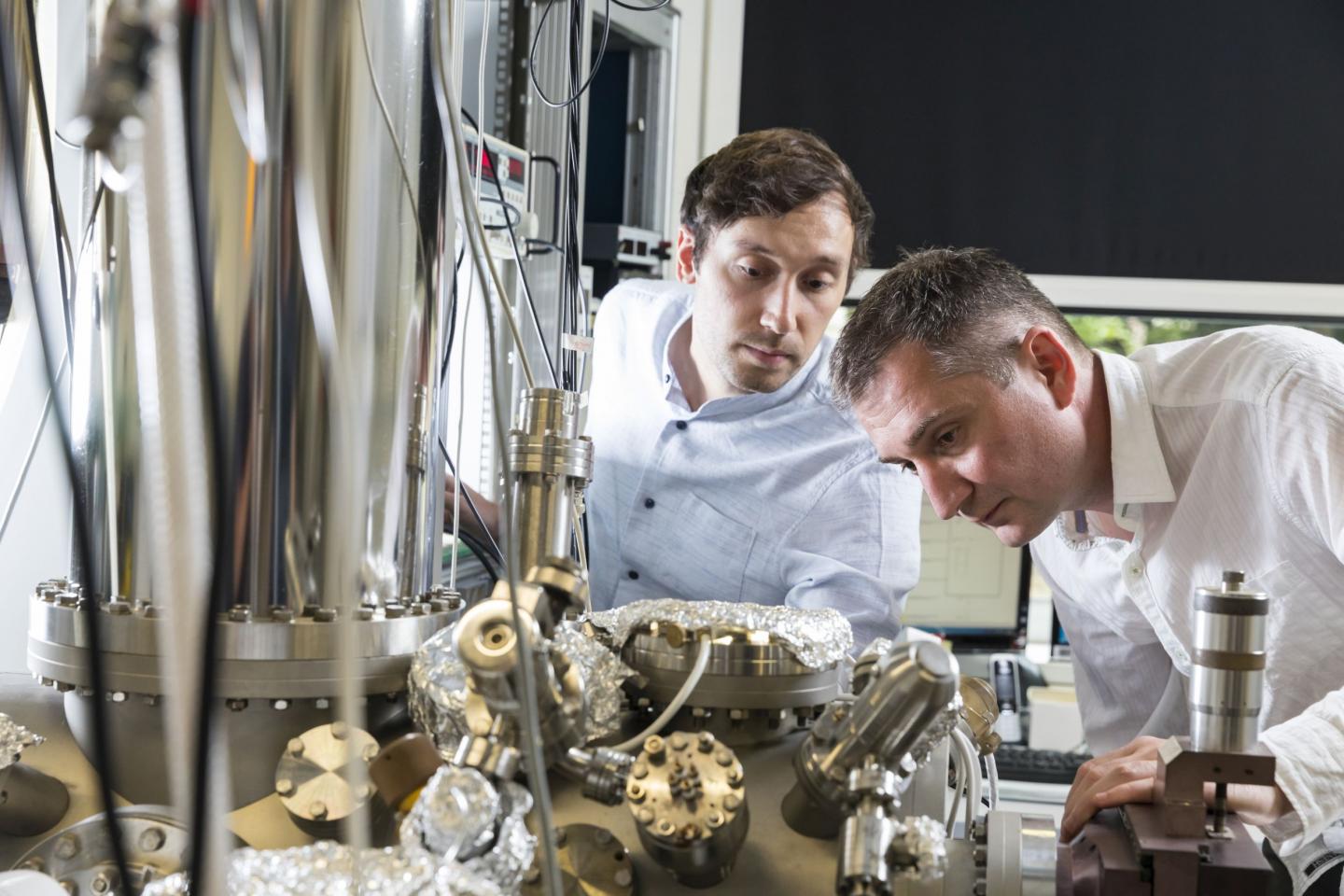 Researchers Next to a Scanning Probe Microscope