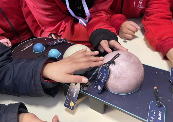 Students interact with a multisensory model of the solar system from Universo Expansivo