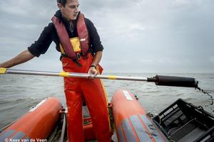 Taking a soil sample from the boat to determine sediment composition and biodiversity of benthic life.