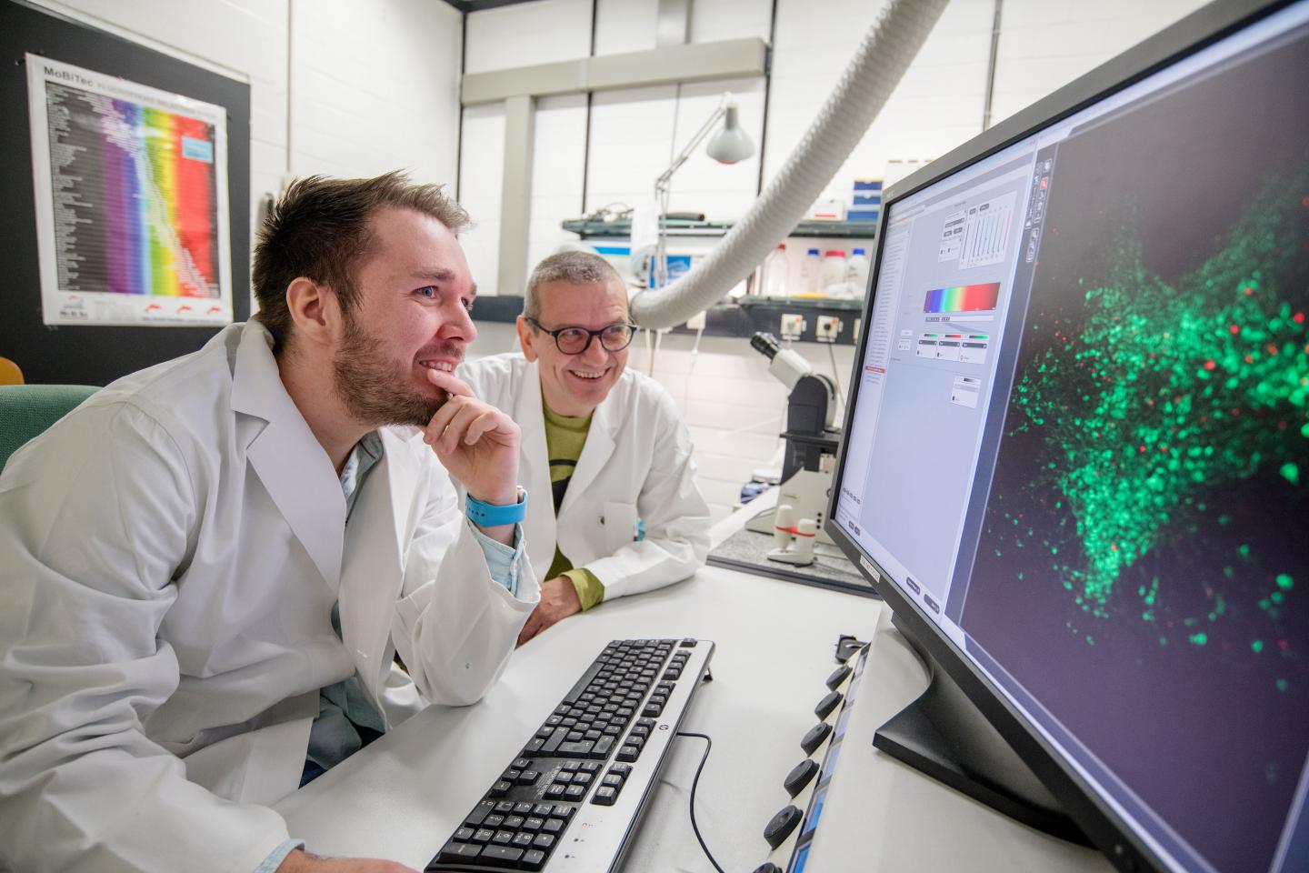 Researchers with Fluorescing Cells