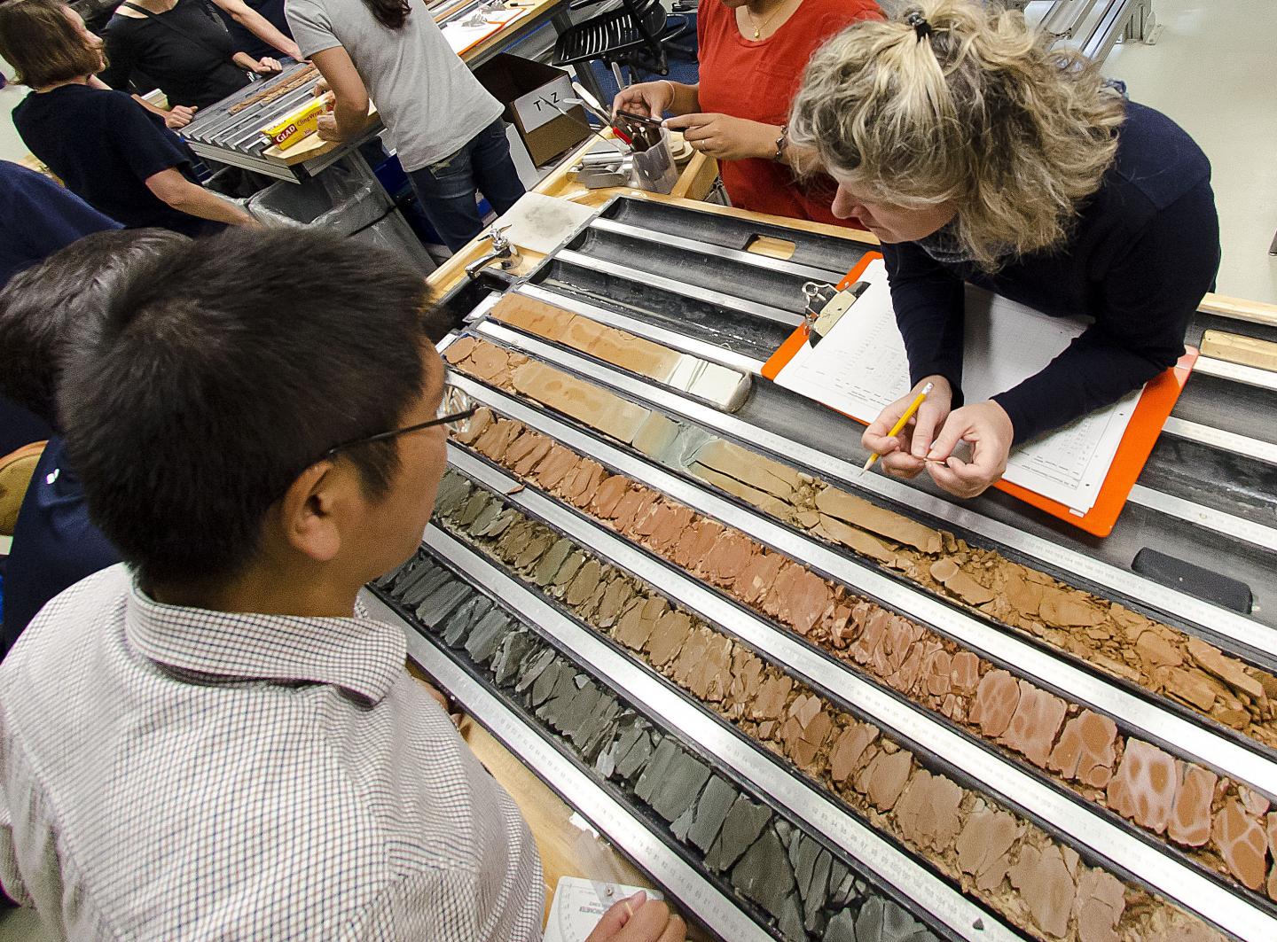 Scientists Examine the Working and Archive Halves of a Freshly Split Core