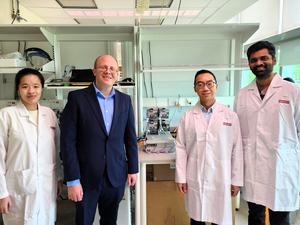 Left to right: SMART researchers Ms. Denise Teo, Dr. Michael Birnbaum, Dr. Wei-Xiang Sin, and Dr. Narendra Suhas Jagannathan, with the microbioreactor system at the centre.