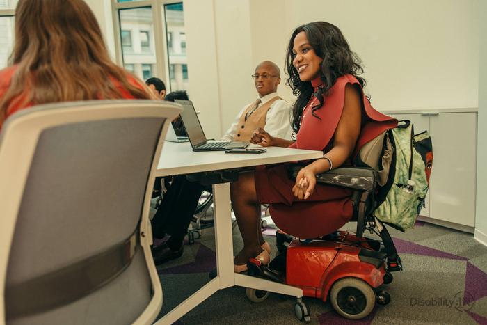 Employees with disabilities meet in a conference room.
