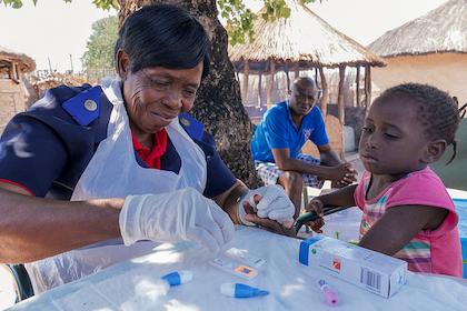 A study nurse performs malaria testing and treatment in villages in the Zambezi Region of Namibia, Africa, in 2017.