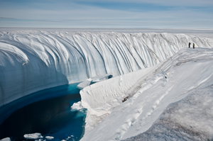 Surface meltwater flowing towards the ocean through a channel in Greenland