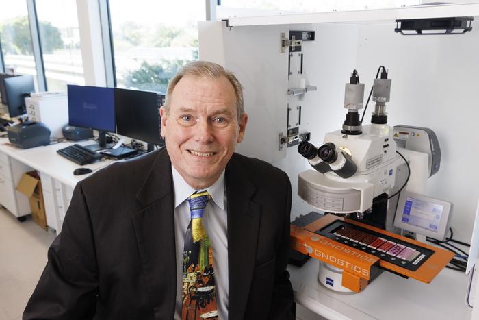 Professor Brian Lovell with an automated micrscope scanner