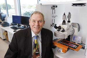 Professor Brian Lovell with an automated micrscope scanner