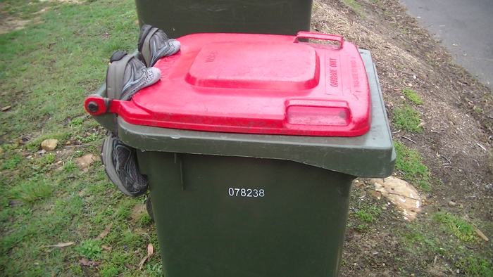 Shoes keep a bin lid from opening