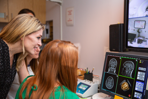 Professor Marsh looks over MRI scans with students in her lab.