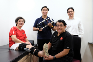 Foreground: Centre for Orthopaedics Chairman & CEO Dr Jeffery Chew, knee replacement patient Mdm Teo Lee Lee who is wearing the X-Brace
