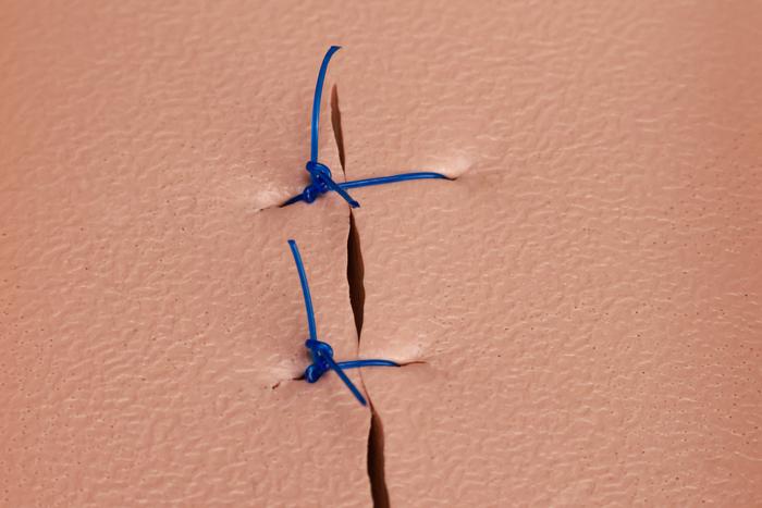Surgical knot tied on a suturing pad