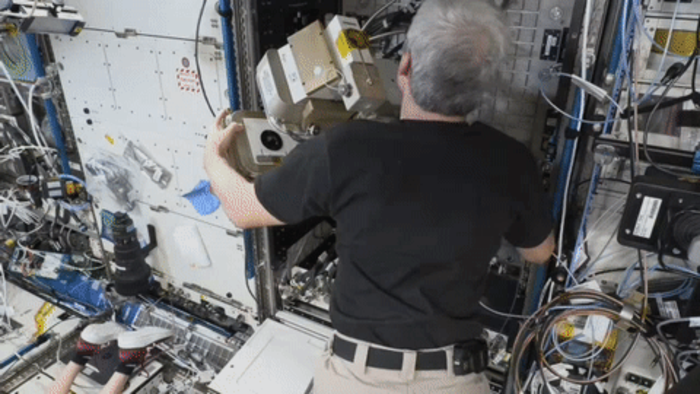 NASA astronaut Mark Vande Hei uninstalls the Light Microscopy Module from the station