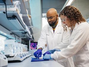 Action shot of first author and corresponding author in the lab