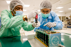 Malawian PhD student Christopher Luwanga working on the SCOOB-I satellite with Yeoh Jun Kai at NTU Singapore