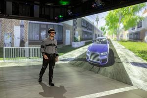 Participant interacting as a pedestrian in a driver-pedestrian simulator