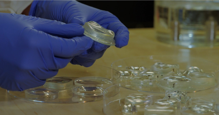 Lenses made by shaping fluids