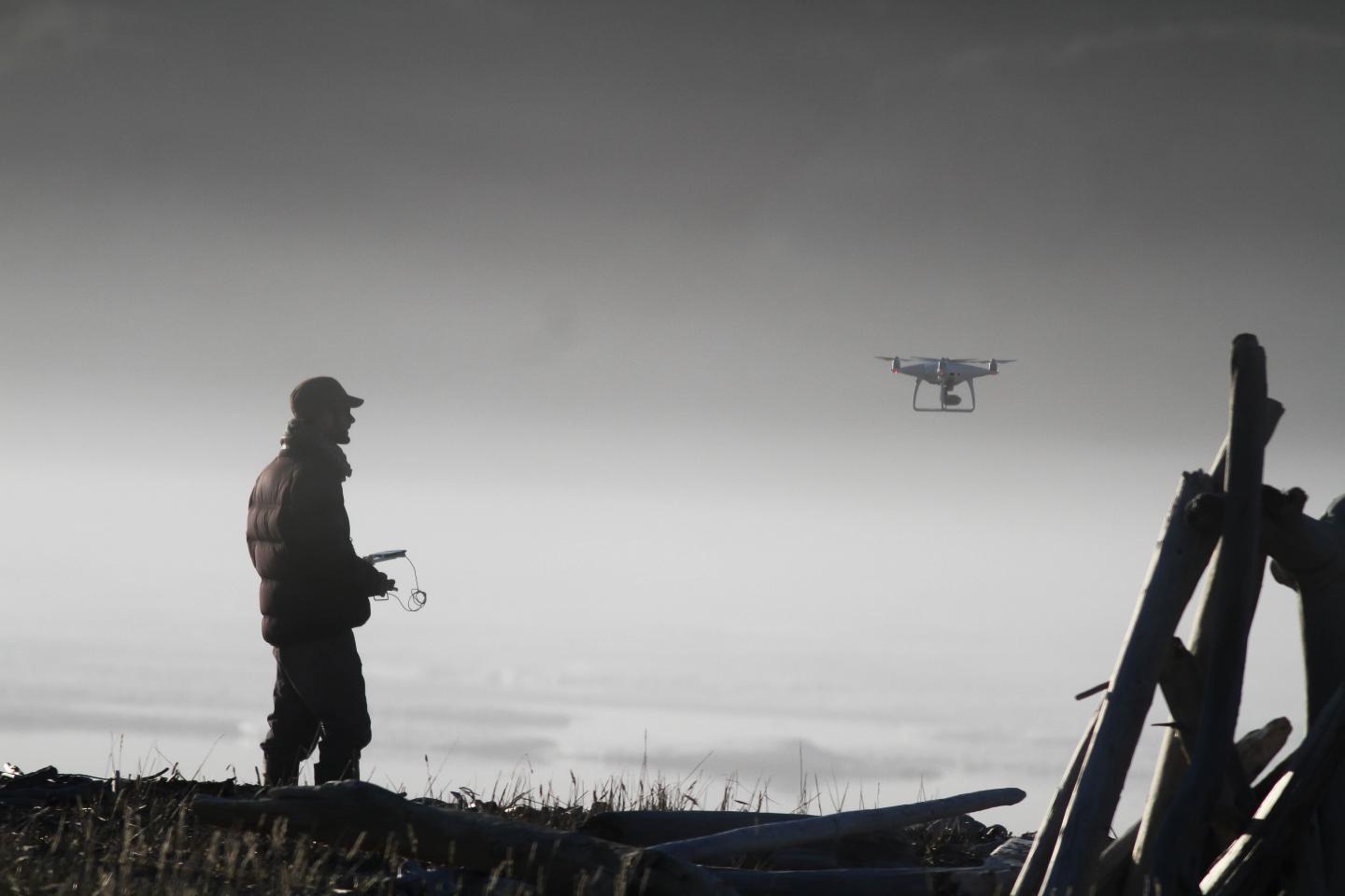 A Researcher Flies a Drone in the Arctic Mist
