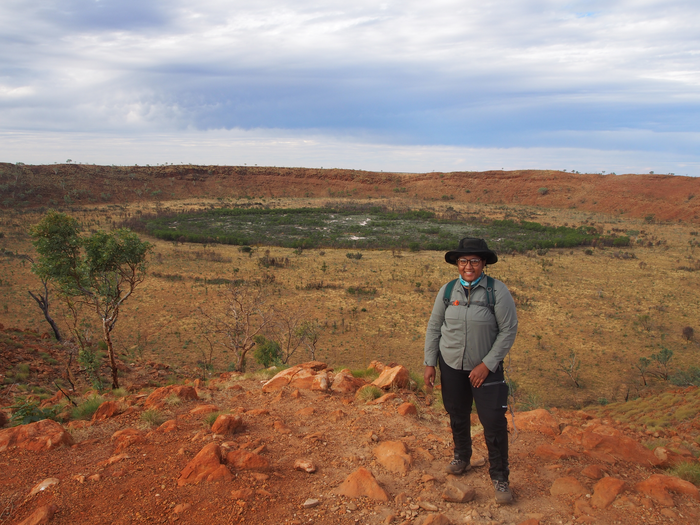 Dr. Tanisha Williams on the rim of the Wolfe Creek Meteorite Crater